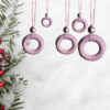 Handmade pink macrame Christmas ornament with a 2.25-inch diameter, featuring delicate craftsmanship.