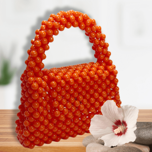 Handcrafted orange beaded bag with a unique, eye-catching design.