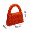 Handcrafted orange beaded bag with a unique, eye-catching design.