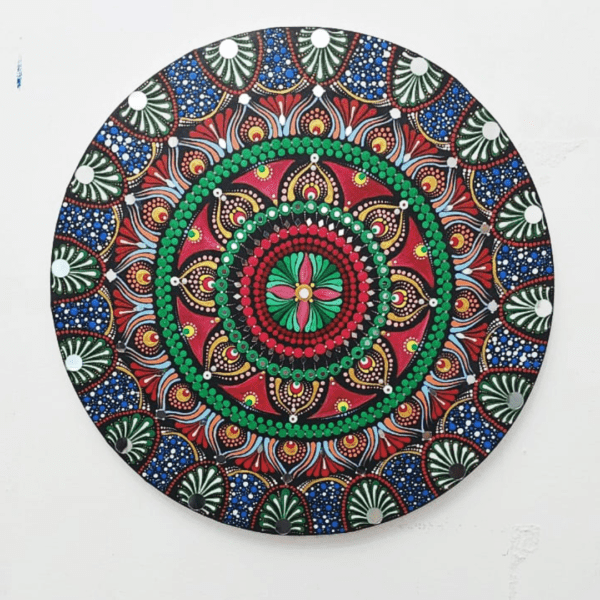 Blooming Radiance Mandala, a 40 cm handcrafted mandala art on canvas by Krutika Jariwala, featuring intricate patterns with bold red, green, and blue hues.