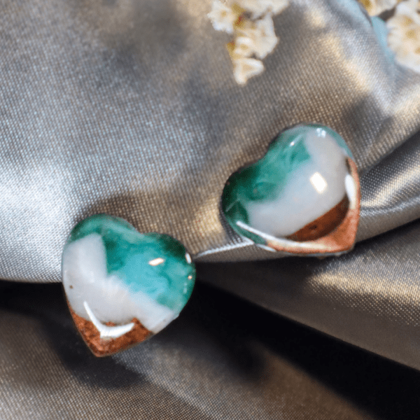 Handcrafted heart-shaped clip-on earrings depicting turquoise water, white waves, and golden sand, with golden stainless steel backs, lightweight and elegant.