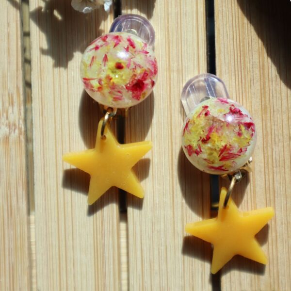 Handcrafted yellow star clip-on earrings with floral resin studs, lightweight at 2g, 3.5 cm long, with gold-plated stainless steel backs