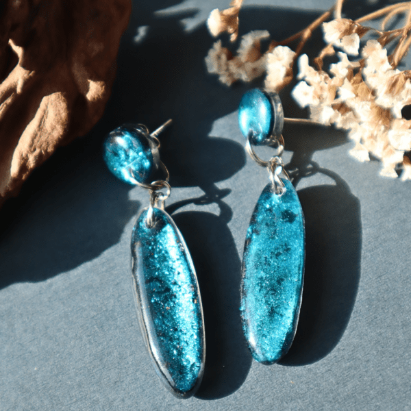 Handmade resin earrings with vibrant blue shimmer, 6 cm long, lightweight at 3-4g, with stainless steel studs