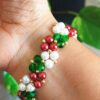 Handmade Christmas bracelet crafted with high-quality Japanese pearl beads in vibrant seasonal colors, ideal for festive outfits.