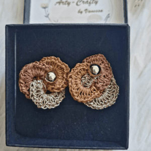 A pair of handmade Anastasia Ear Studs by Arty-Crafty by Vanessa, featuring intricate crochet circles in earthy tones with a subtle shimmer, embellished with sparkling studs