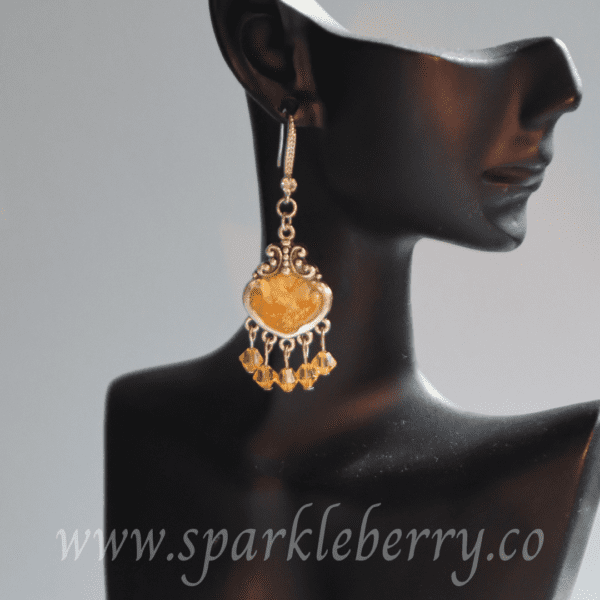 Handcrafted golden resin earrings with genuine Swarovski beads and silver-toned filigree design