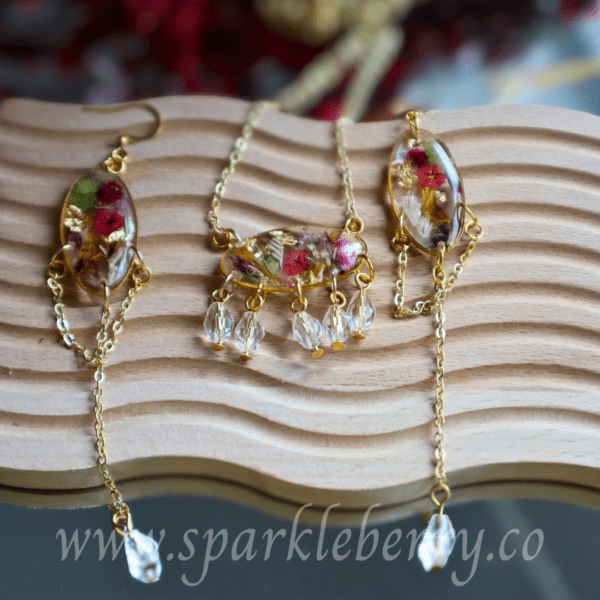 Handcrafted earring and necklace set with dried flowers, gold flakes, crystal beads, and gold-plated stainless steel chain.