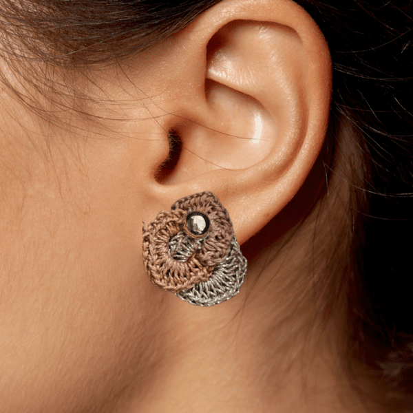 A pair of handmade Anastasia Ear Studs by Arty-Crafty by Vanessa, featuring intricate crochet circles in earthy tones with a subtle shimmer, embellished with sparkling studs