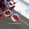 Romantic rose gold earrings featuring real red roses and gold foil accents encased in resin, with hypoallergenic gold-plated hooks.