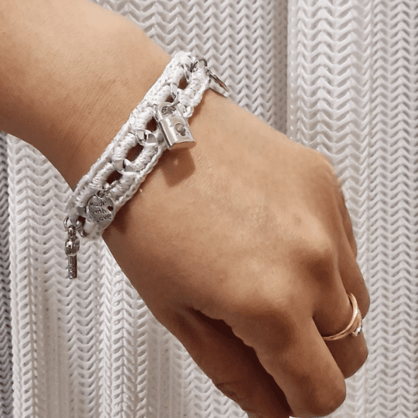 A handcrafted crochet and metal-link Felicity Bracelet featuring delicate charms