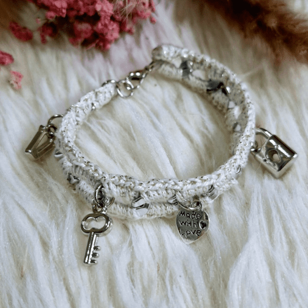 A handcrafted crochet and metal-link Felicity Bracelet featuring delicate charms