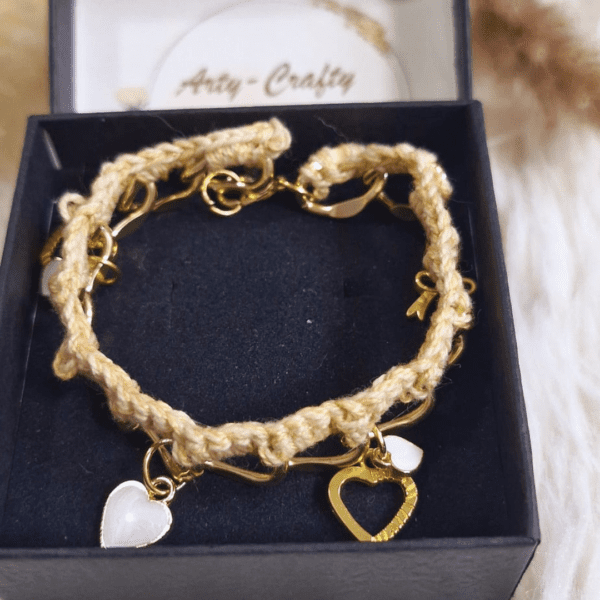 A handcrafted crochet and metal-link Felicity Bracelet featuring delicate charms