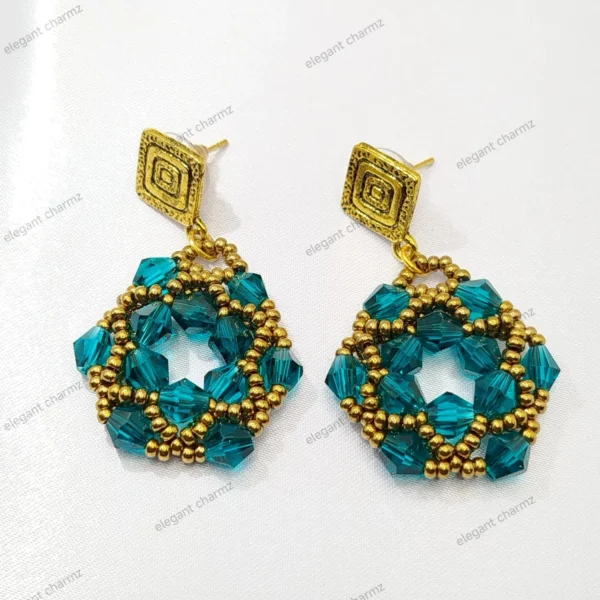 Handmade Emerald Beaded Earrings displayed on a white background, featuring teal faceted crystals, gold beads, and textured gold square studs.