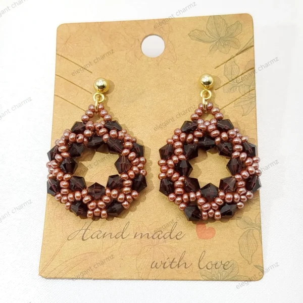 Handmade Eternal Glow Beaded Earrings featuring an intricate circular design with brown and bronze beads, accented with gold-tone stud tops.