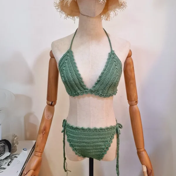 Mannequin wearing a sage green crochet bikini set with a triangle top and tie-side bottoms.