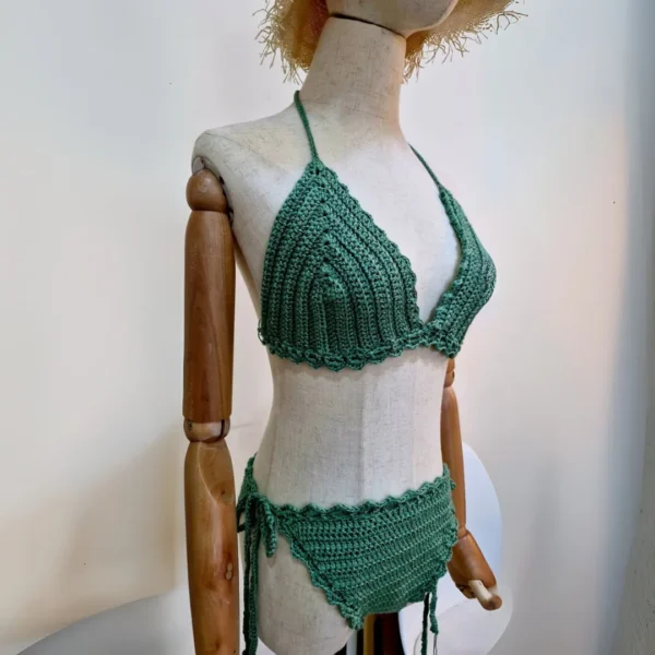 Side view of a sage green crochet bikini set on a mannequin, featuring delicate scalloped edges.