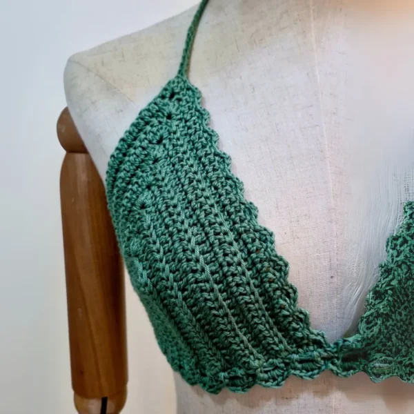 Close-up of the crochet bikini top, highlighting its delicate stitching and scalloped trim.