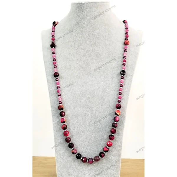 Handmade pink and purple Agate-look bead necklace with faceted and pearl-like beads, displayed on a gray bust stand.