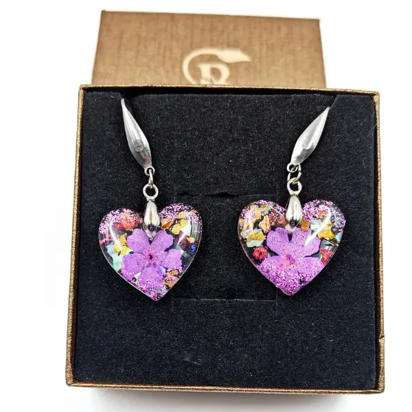 Handmade resin heart earrings with real purple flower inside presented in brown Sparkleberry box
