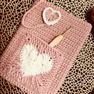 Handmade pink Crochet Book Sleeve with cream heart pocket and flap closure
