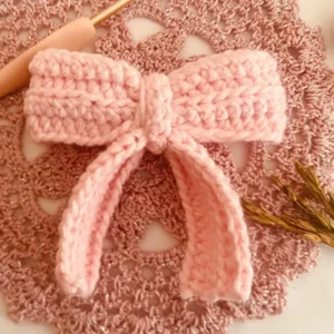 Handmade pink Crochet Hair Bow with textured stitches and long tails