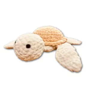 Handmade cream and beige crochet sea turtle plushie displayed on a white background.